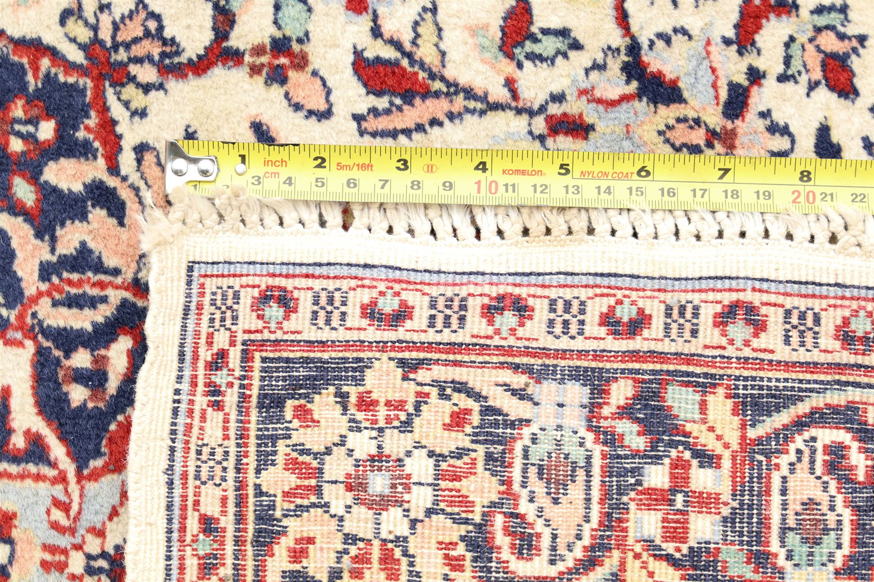 Two Persian rugs, Persian Hamadan hand-knotted rug, ivory ground centred by a terracotta medallion, surrounded by scrolling floral and foliate motifs, dark navy floral border with narrow guard stripes, fringed ends, H 176cm, W 75cm, Persian tribal hand-knotted rug, madder red ground decorated with three large geometric medallions, surrounded by angular motifs, enclosed by multiple geometric borders in dark navy, ivory and red, fringed ends, H 150cm, W 91cm