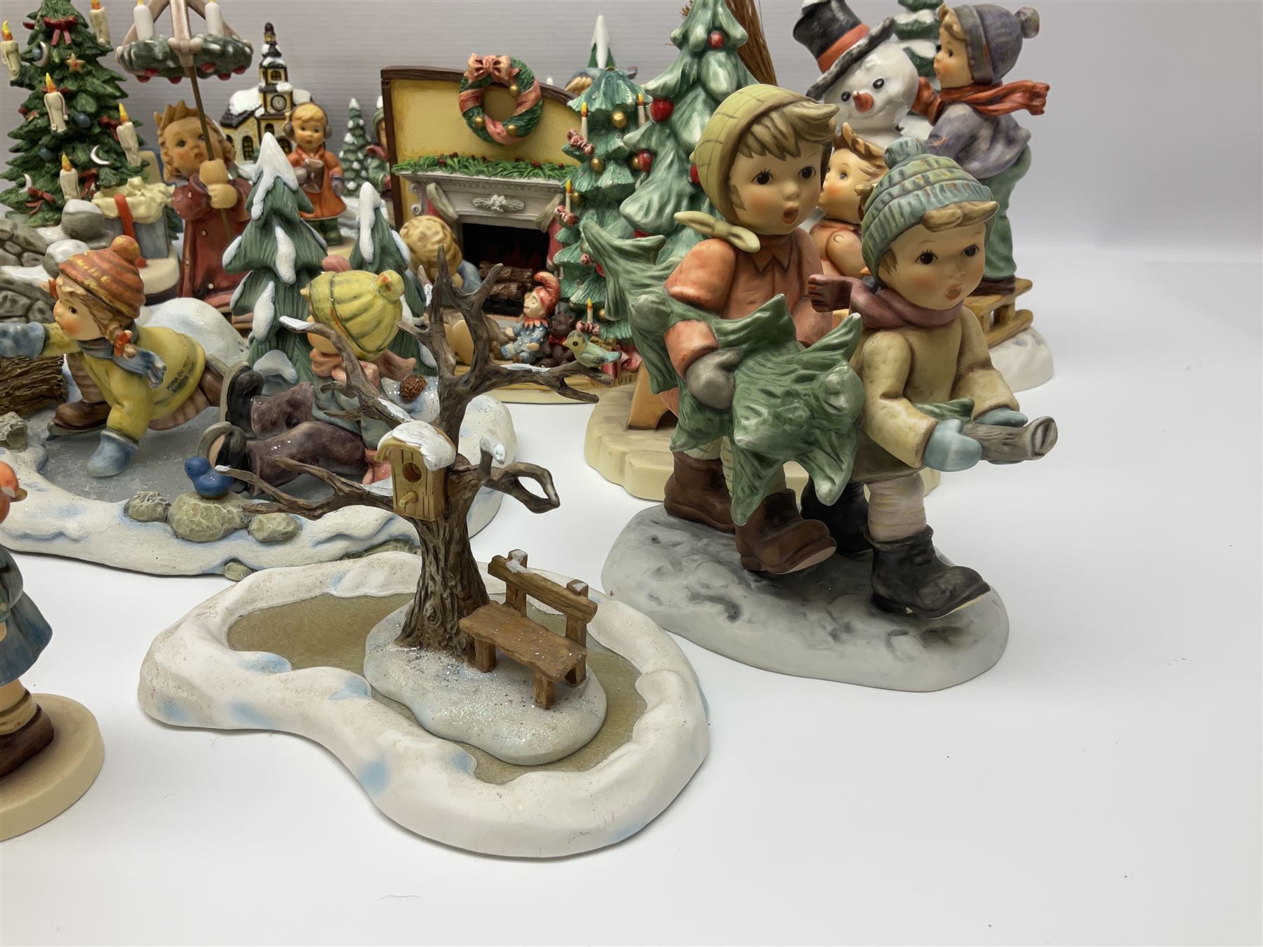 Large collection of Christmas themed Hummel figures and Hummel scapes by Goebel, to include Winter Friend, Making New Friends, Tree Trimming Time, Winter Adventure etc