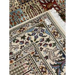 Persian Heriz design rug, ivory ground with rectangular panels each depicting garden scenes of tree of life, plants and Boteh motifs, the guarded border decorated with wildlife and bird scenes