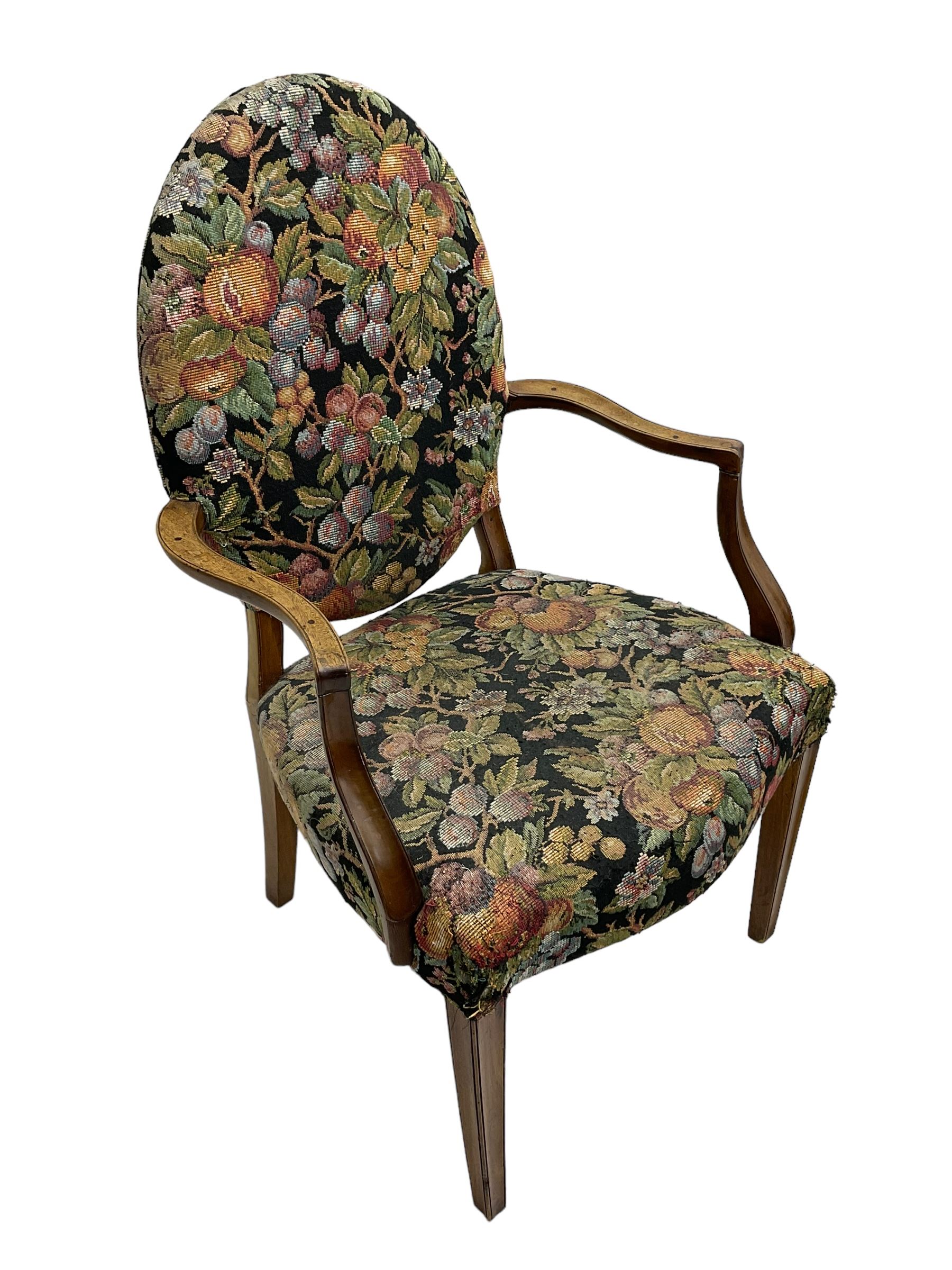 Pair of George III mahogany framed open armchairs, oval back and serpentine seat upholstered in fruit and foliage patterned fabric, shaped and moulded arms and arm supports, on square tapering moulded front supports 
