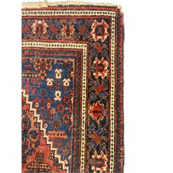 Persian Hamadan red ground rug, the field decorated with floral motifs with central lozenge medallion, guarded border decorated with repeating stylised plant motifs