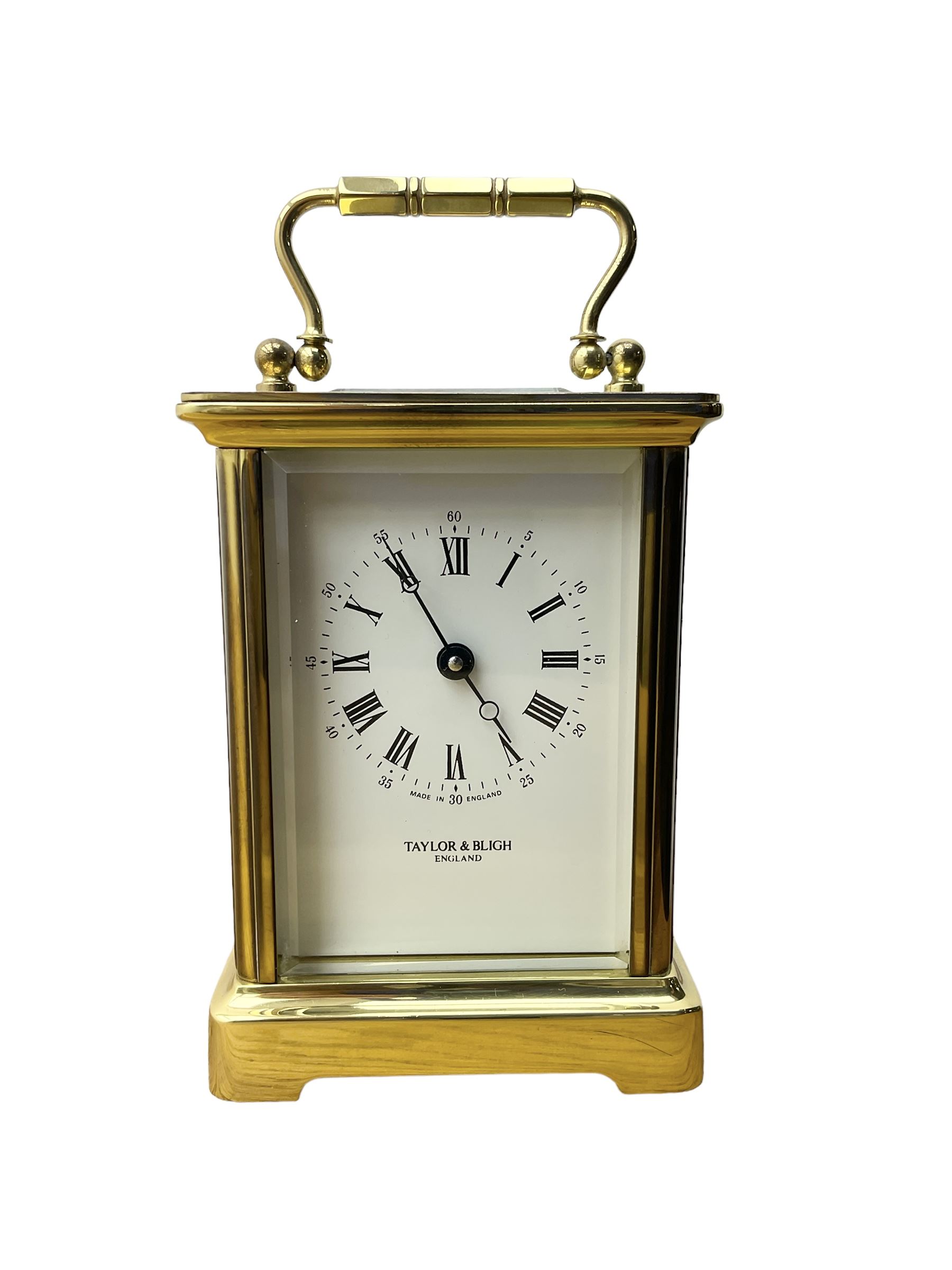 Taylor & Bligh - English 8-day carriage clock in a corniche-style case, white dial with roman numerals and steel moon hands, 11 jewel movement with a lever platform escapement. With key.