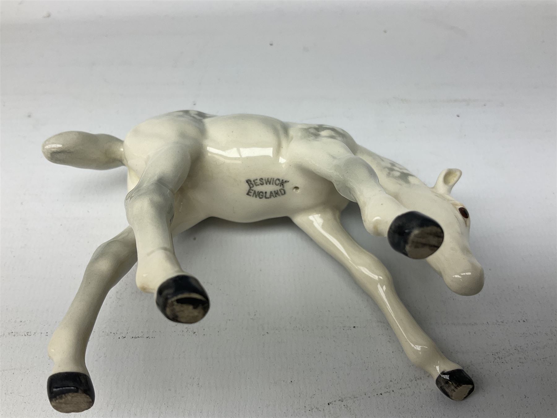 Collection of Beswick horses, including grey horse no.701, palomino foal no 836, grey stocky jogging mare no.855 etc, together two Royal Doulton horses, (8)