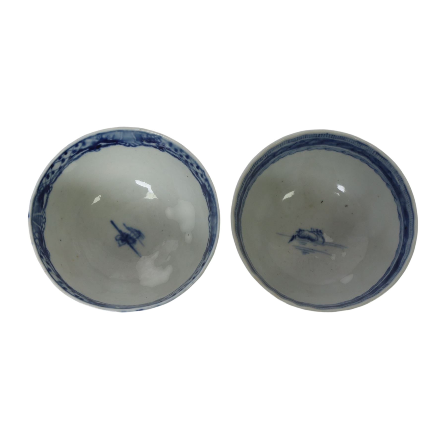 Two 19th century Chinese blue and white tea bowls, each decorated with traditional landscapes, together with two similar saucers, tea bowl H5cm, D9cm  