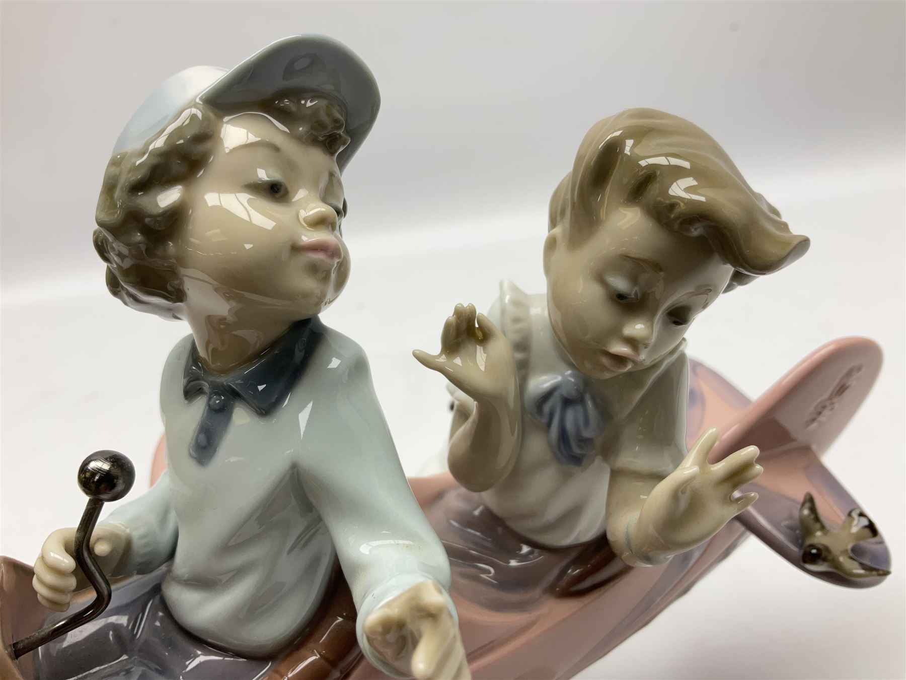 Lladro figure, Don't Look Down, modelled as a girl and boy in a plane, sculpted by Joan Coderch, no 5698, year issued 1990, year retired 2004, H17cm