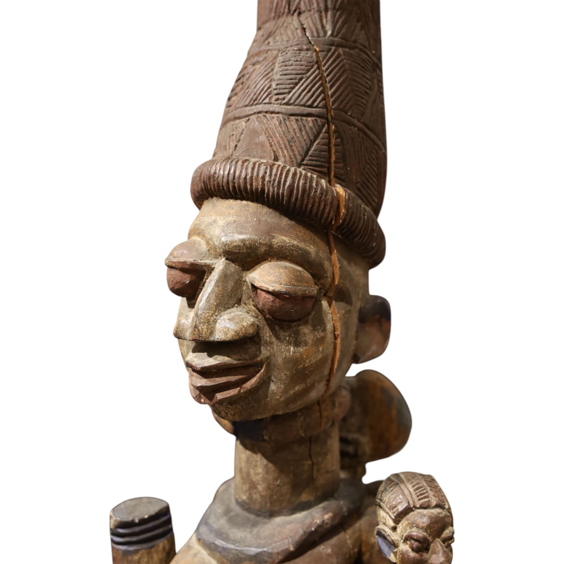 African tribal maternity figure of a woman with children, probably Yoruba, carved wood, the woman stood upon a craved mask, H133cm