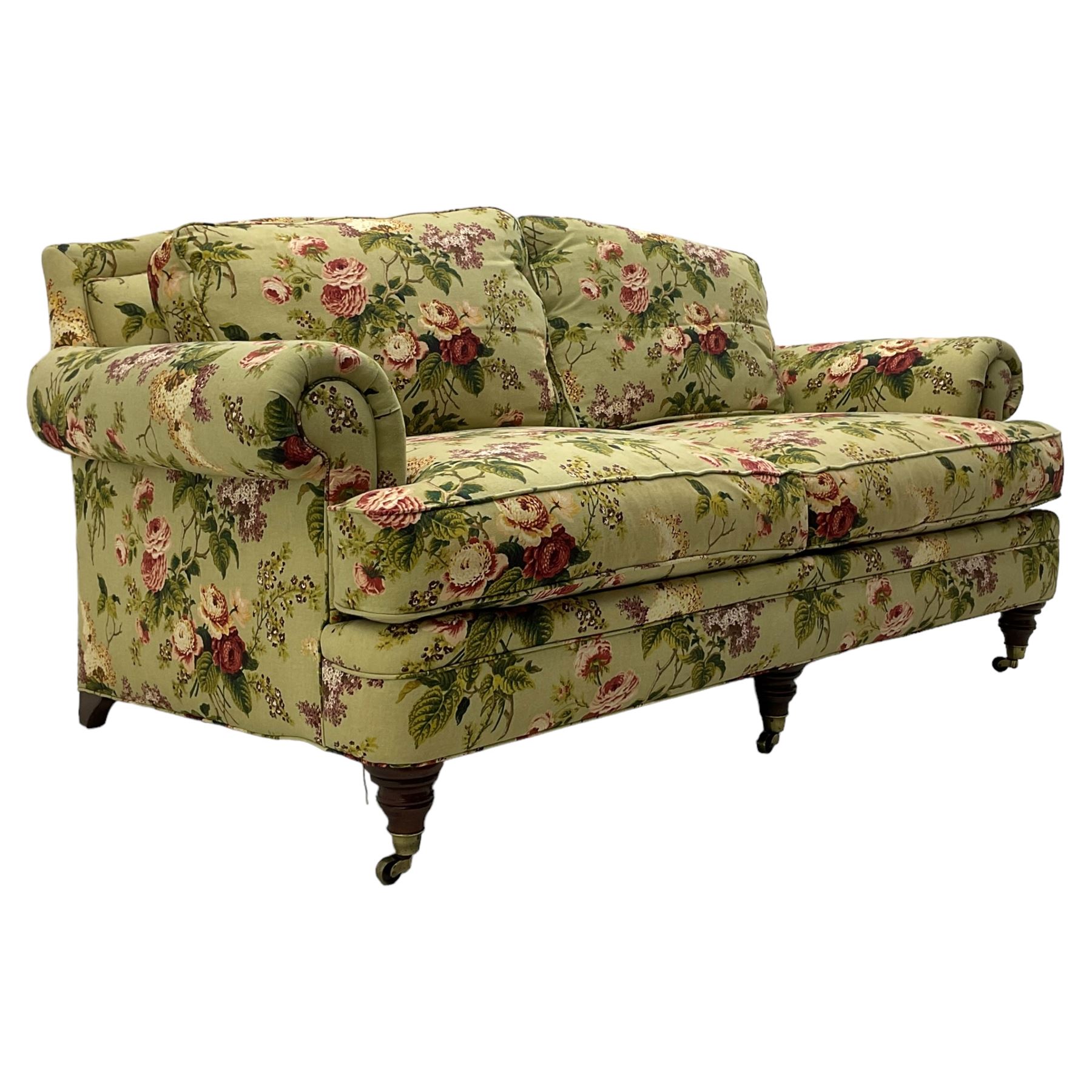 Hancock & Moore - two-seat sofa, upholstered in pale green ground fabric decorated with floral pattern, traditional shape with rolled arms and arched back, on turned front feet with brass cups and castors 