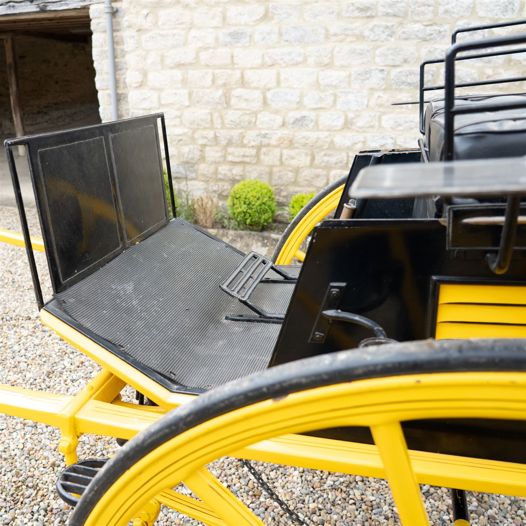 J. W. Thompson Dog Cart

A black and yellow painted two wheeled dog cart with elevated upholstered seat for two, buttoned black leather cushions, high back rail, folding front footboard, louvred sides, side steps, rear drop-down tailboard with chain stays, internal storage compartment, wooden spoked wheels, rubber tyres and shafts for a single horse. The wheel hubs are marked J W Thompson

Dimensions:
Overall length: 366 cm
Width: 160 cm
Height: 190 cm

Wheel Diameter:
Wheels: 139 cm

Seating:
Driver and passenger: 2