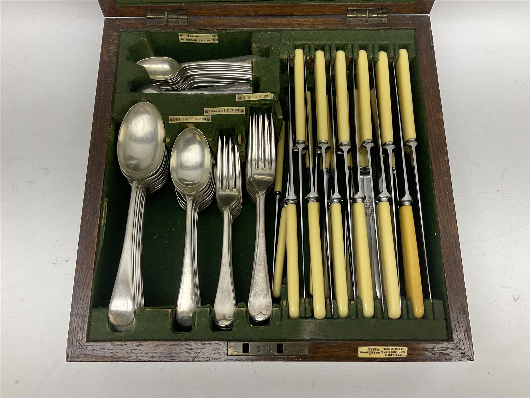Walker and Hall silver plated canteen of cutlery, oak case, the hinged lid with a engraved brass shield , H12cm, L32cm