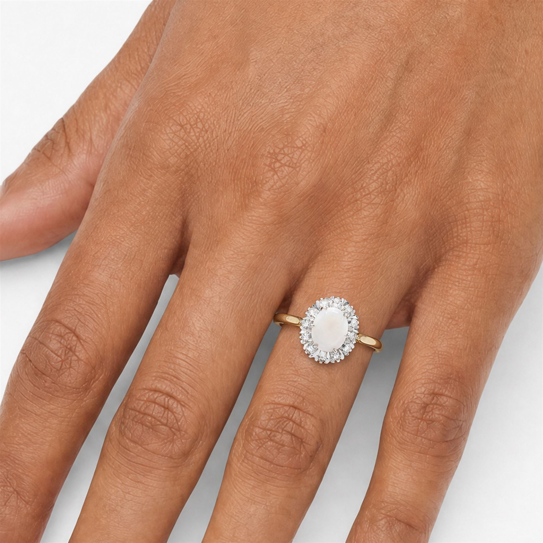 18ct gold opal and diamond cluster ring, oval cabochon cut opal surrounded by twelve single cut diamonds, London 1988