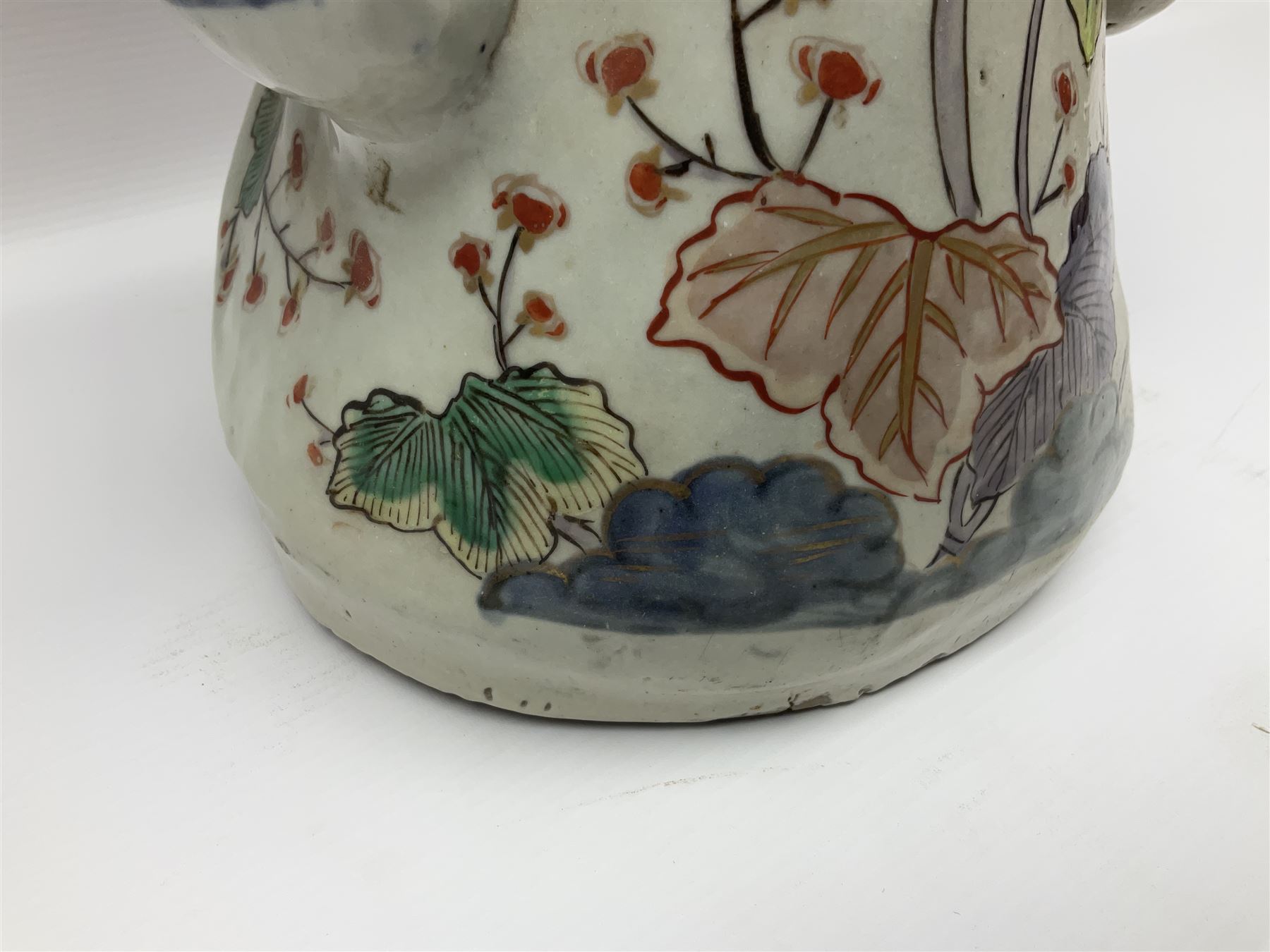 Large Japanese Imari porcelain figure, modelled as a Bijin, wearing a long kimono decorated with apple blossom and leafy branches on a white ground, with gilt detailing, possibly Edo period, H63cm