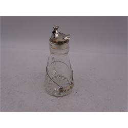 Modern Scottish silver mounted glass whisky tot, with silver whisky label, the glass body with C handle and star cut base, the silver collar and cover with thumbpiece, tot and label hallmarked Edinburgh1996, maker's mark K.M.S, tot including thumbpiece H10.5cm