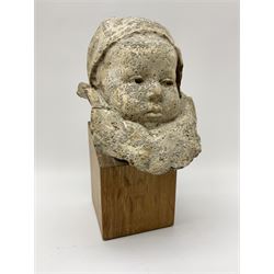 Composite stone bust depicting a baby with ruffle on a oak plinth, H27cm
