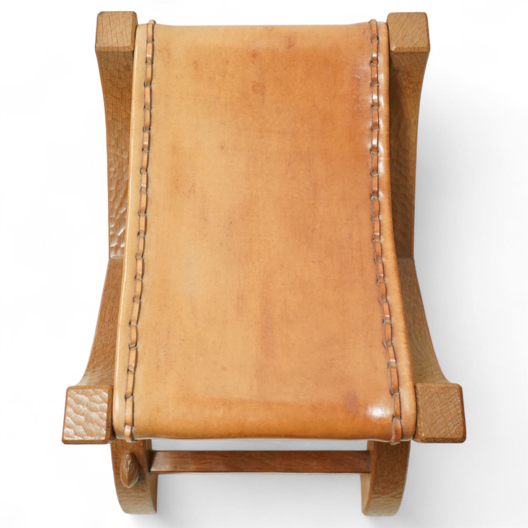 Rabbitman - curved x-framed stool with slung leather seats, adzed throughout the frame with signature Rabbit carving by Peter Heap of Wetwang