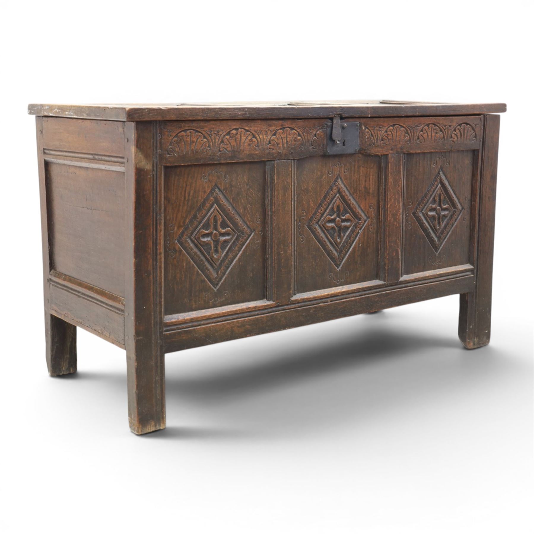 18th century style oak coffer, panelled rectangular top hinged to reveal storage with candle box, carved frieze and front panels, raised on stile feet