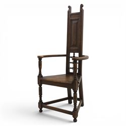 Manner of Liberty & Co. - Arts & Crafts oak Shakespeare chair, high back over triangular seat, flanked by swept arms, raised on turned and block supports united by stretchers