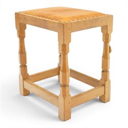 Mouseman - oak dressing table stool, the rectangular tan leather padded seat with studwork border, raised on octagonal supports united by box stretcher, carved with mouse signature, by the workshop of Robert Thompson of Kilburn
