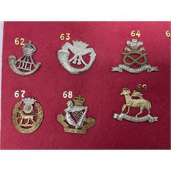 Twenty cap badges including Welsh Guards, Kings Royal Irish Hussars, York & Lancaster,  Loyal Suffolk Hussars, North Stafford, Durham Light Infantry, Cheshire, West Yorkshire, Norfolk, South Wales Borderers, Dorsetshire etc; mounted on a board for display
