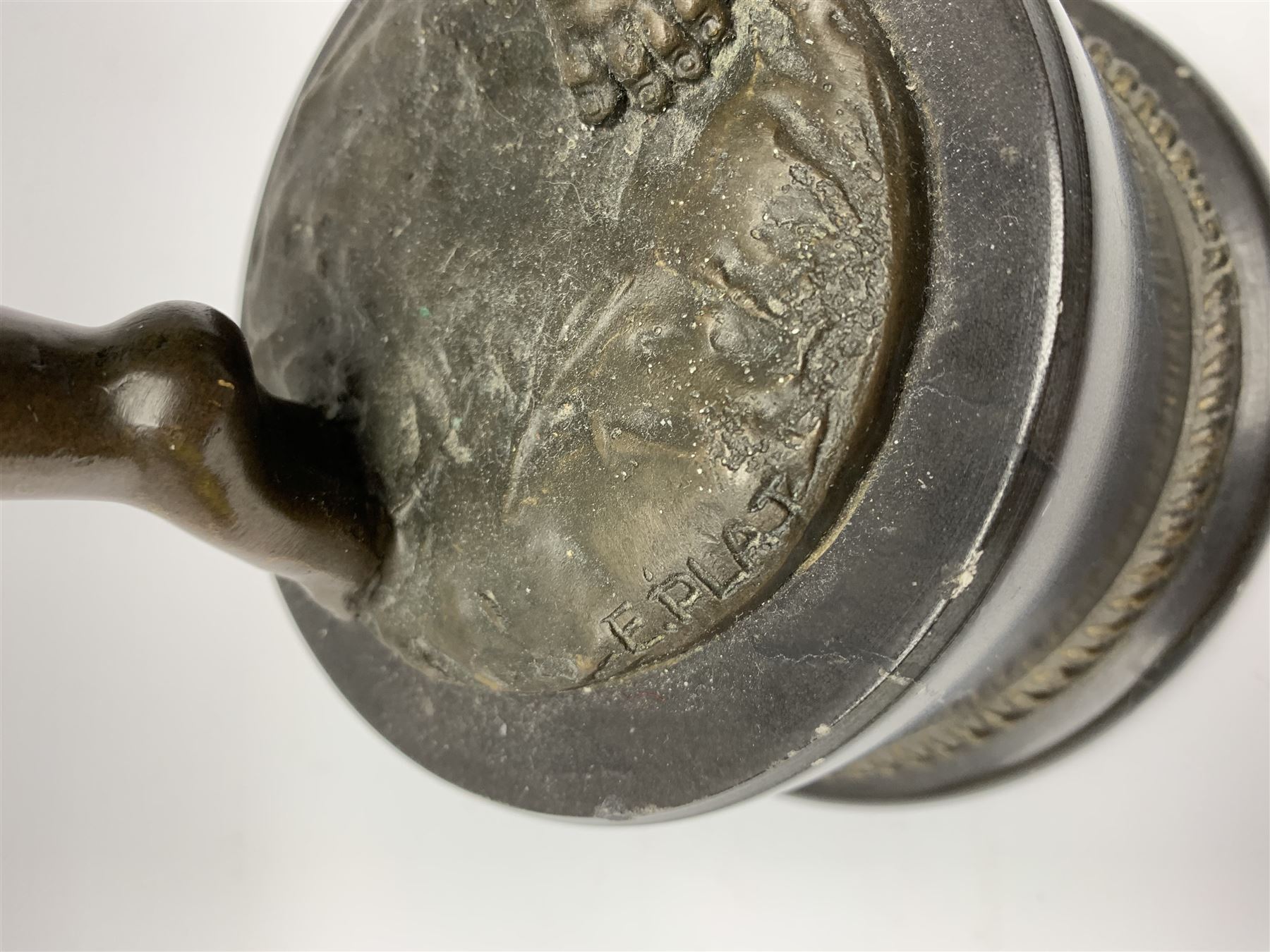 After E Plat, bronze modelled as a dancing child, signed E. Plat, upon cylindrical black marble base, H40cm