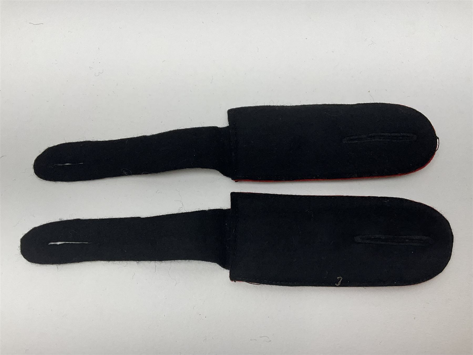 Collection of eleven German metal and cloth badges and uniform buttons including driver's badge, two 'SS' fabric skulls, private's shoulder tabs, Police cloth badge, tank destruction badge, medal bars and ribbon etc; most WW2 period