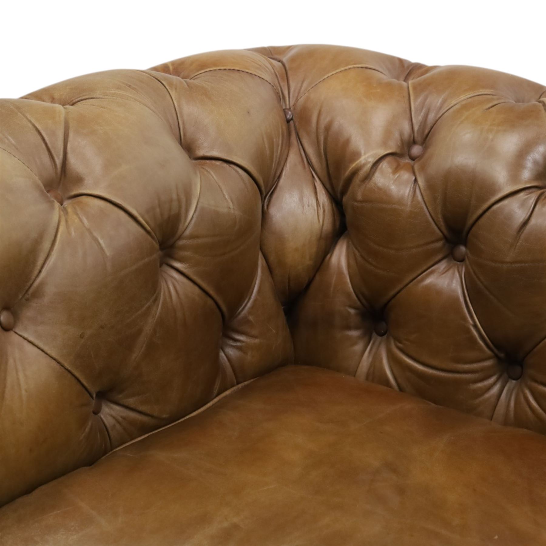 Timothy Oulton for HALO - Two seater brown leather chesterfield sofa, with button back and arms, with two loose cushions, raised on a dark stained supports terminating in castors 