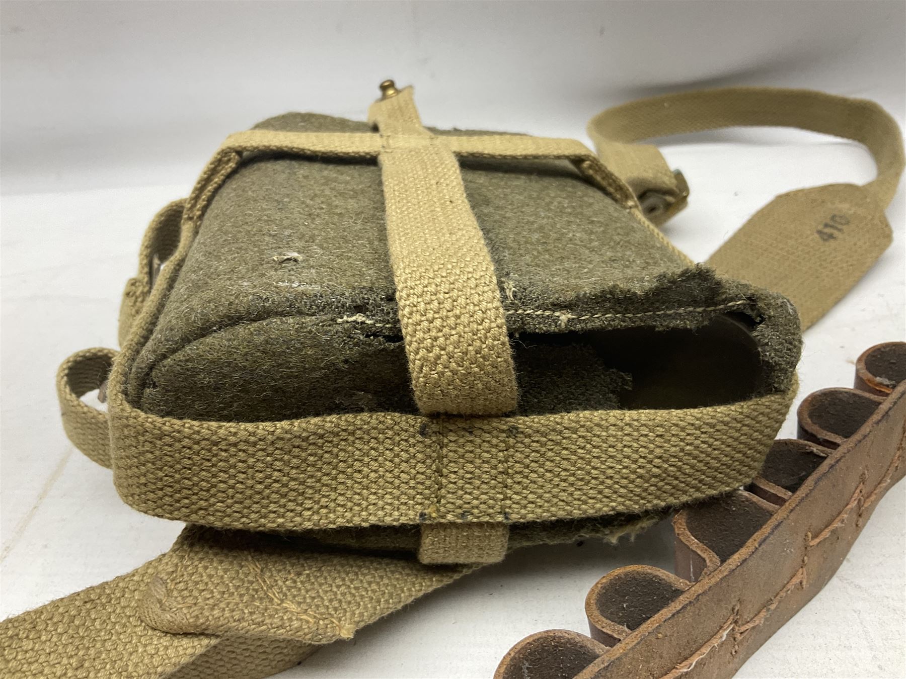 Mundial Brazil bowie knife, the 15.5cm steel blade inscribed 'Sheriff Knife', with banded and aluminium hilt; in leather sheath L29cm overall; British Army felt covered metal water bottle with webbing strap; leather 12-bore cartridge belt; and small pair of non-military binoculars in part case (4)