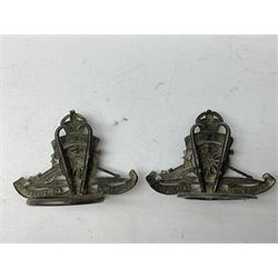Trench Art - three WW2 brass shell case ashtrays, one mounted with Royal Artillery cap badge and button and one mounted with RA button; together with a pair of place name holders each formed from a Royal Artillery cap badge (5)