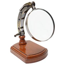 Magnifying glass on wooden stand