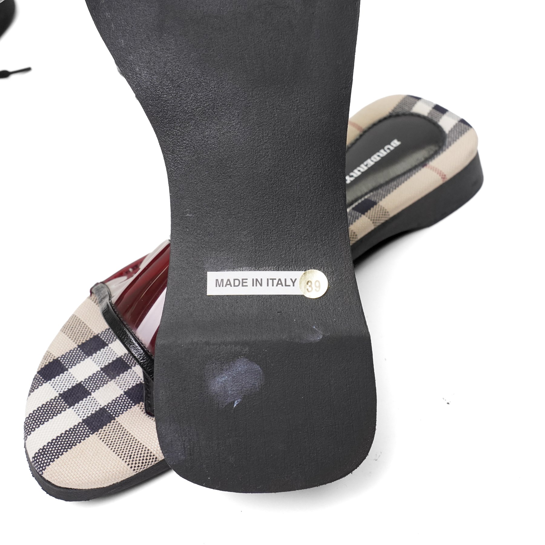 Christian Louboutin and Burberry - two pairs of designer shoes, comprising black leather Christian Louboutin low-top sneakers with black spike-studded toe caps and signature red soles, size 40, with dust bag, together with Burberry check canvas and red transparent strap sandals, size 39, with box and dust bag (2)