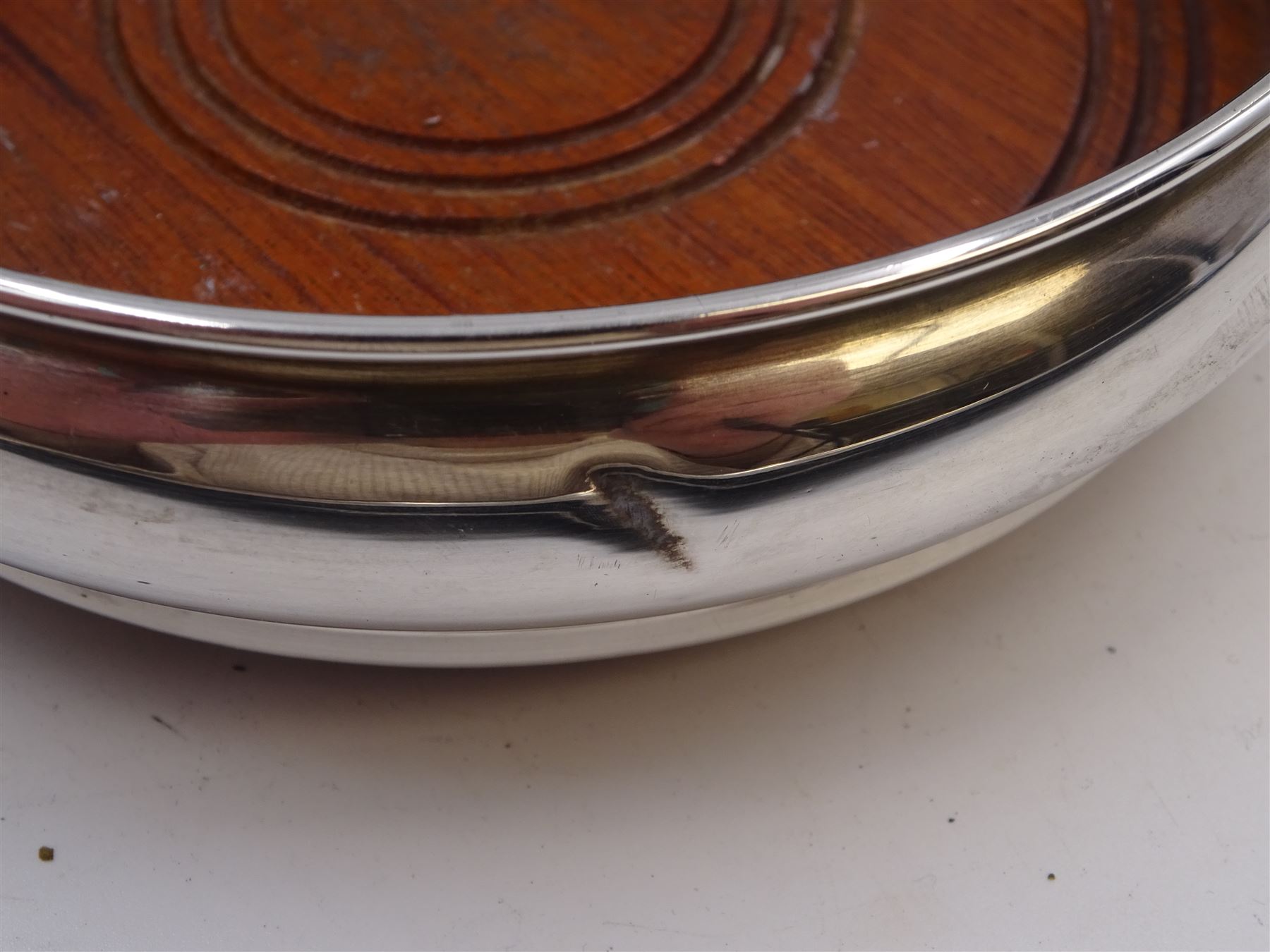 Modern silver mounted bottle coaster, of plain circular form with turned mahogany centre, hallmarked W I Broadway & Co, Birmingham 1979, D13cm