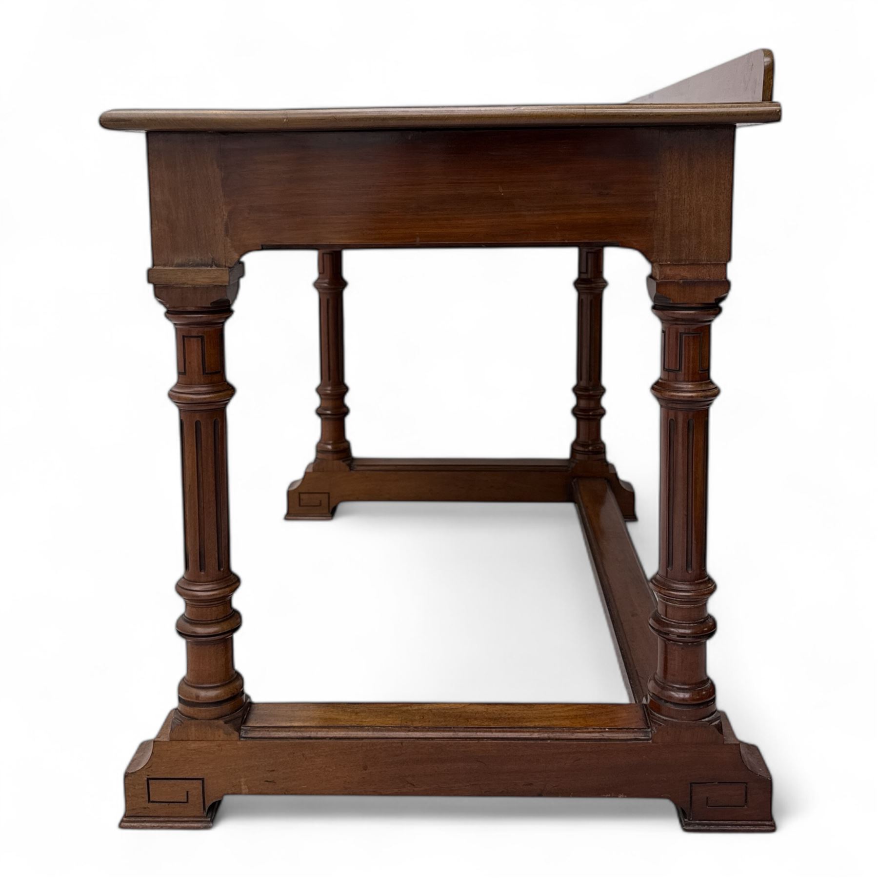 Late Victorian mahogany side table in the style of Gillows of Lancaster, mahogany rectangular top above two frieze drawers, the top edge of the right drawer stamped 'Gillow' and 'L486' with knob handles supported on turned stop and fluted legs with stretcher base on recessed castors

Provenance: The Davies-Cooke Collection from Gwysaney Hall, North Wales  
