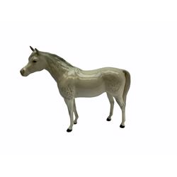 Beswick horse figures, comprising Highland Pony 1644, and another, probably Aran Bahram in grey, each with printed mark beneath.
