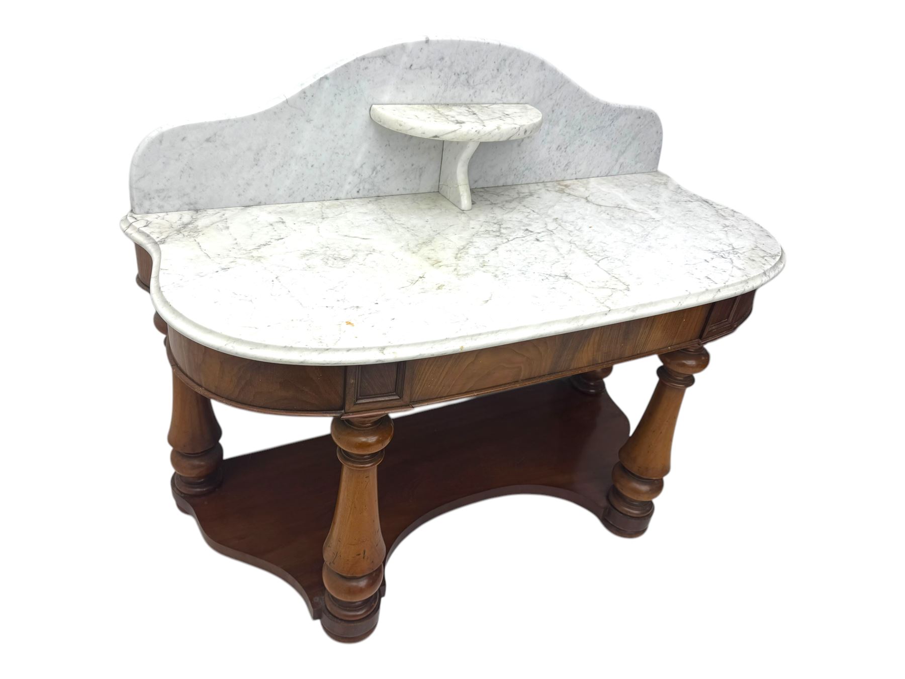 Mid-19th century mahogany washstand, the serpentine white marble top with raised gallery back and central shelf above a frieze drawer, supported by turned columns united by a shaped undertier, raised on bun feet