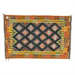 Chobi flatweave kilim with a repeating stepped diamond medallion design in live green, rus...