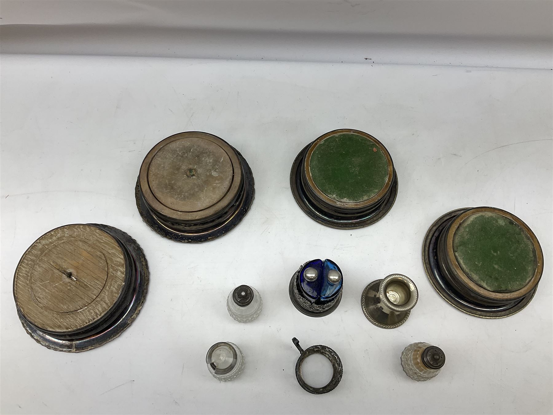 Four 19th century silver plated wine bottle coasters, together with hallmarked silver collared and lidded glass cruet trio and ornate silver cruet holder missing liner, with handle, and other silver plate etc