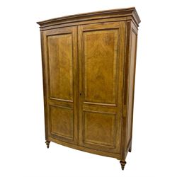 Frank Hudson - mid-20th century Mindi ash and burr walnut double wardrobe, moulded rectangular cornice over two panelled doors with chevron pattern veneers, raised on turned supports