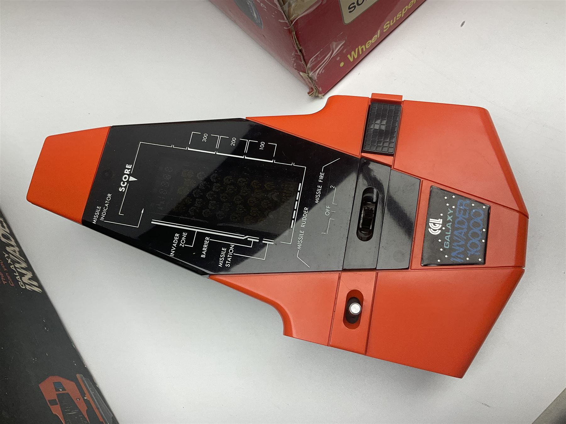 PMS Lightning 1:8 scale remote control racing car; Soma Sonic Man battery operated electronic sounds and light action figure; and CGL Galaxy Invader 10000 computer space battle game; all boxed (3)