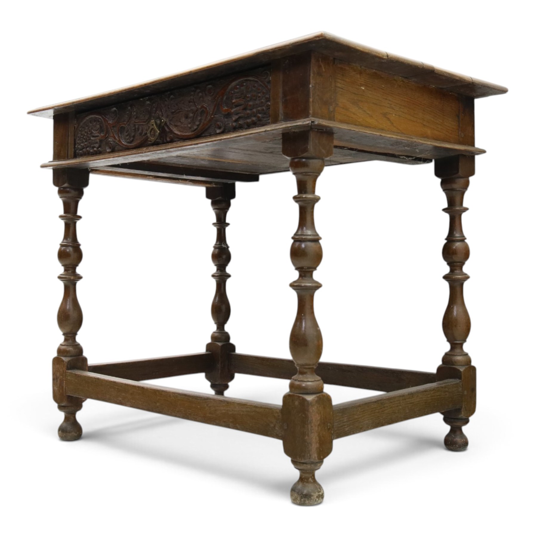 18th century oak lowboy, rectangular top with moulded edge, fitted with single frieze drawer carved with scrolling fruiting vines and stylised plant motifs, raised on bobbin-turned supports united by box stretcher 
