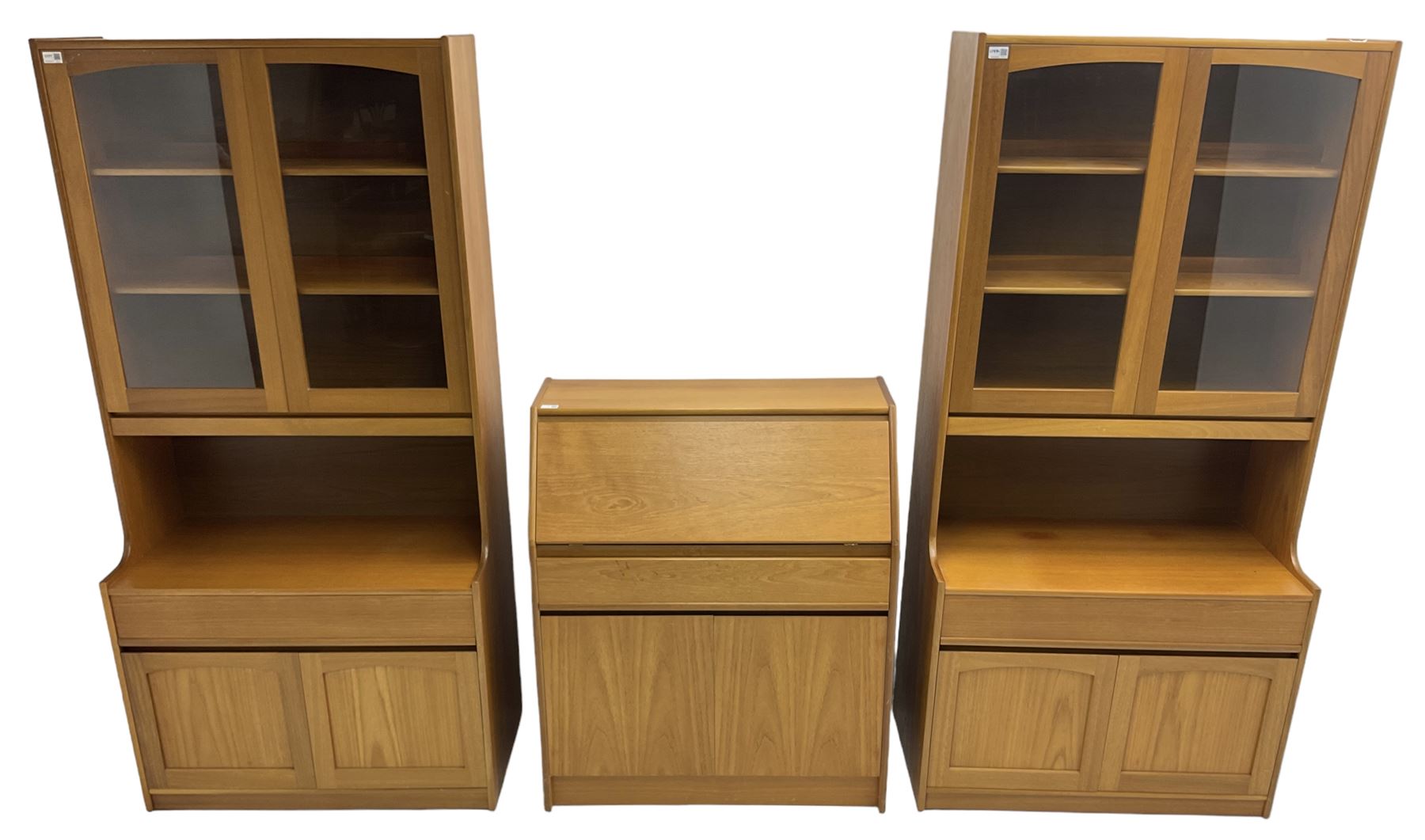 Sutcliffe of Todmorden - pair of teak wall units, fitted with two glazed doors over drawer and double cupboard (W86cm, D45cm, H198cm); and a matching fall front bureau (W84cm, D41cm, H100cm)