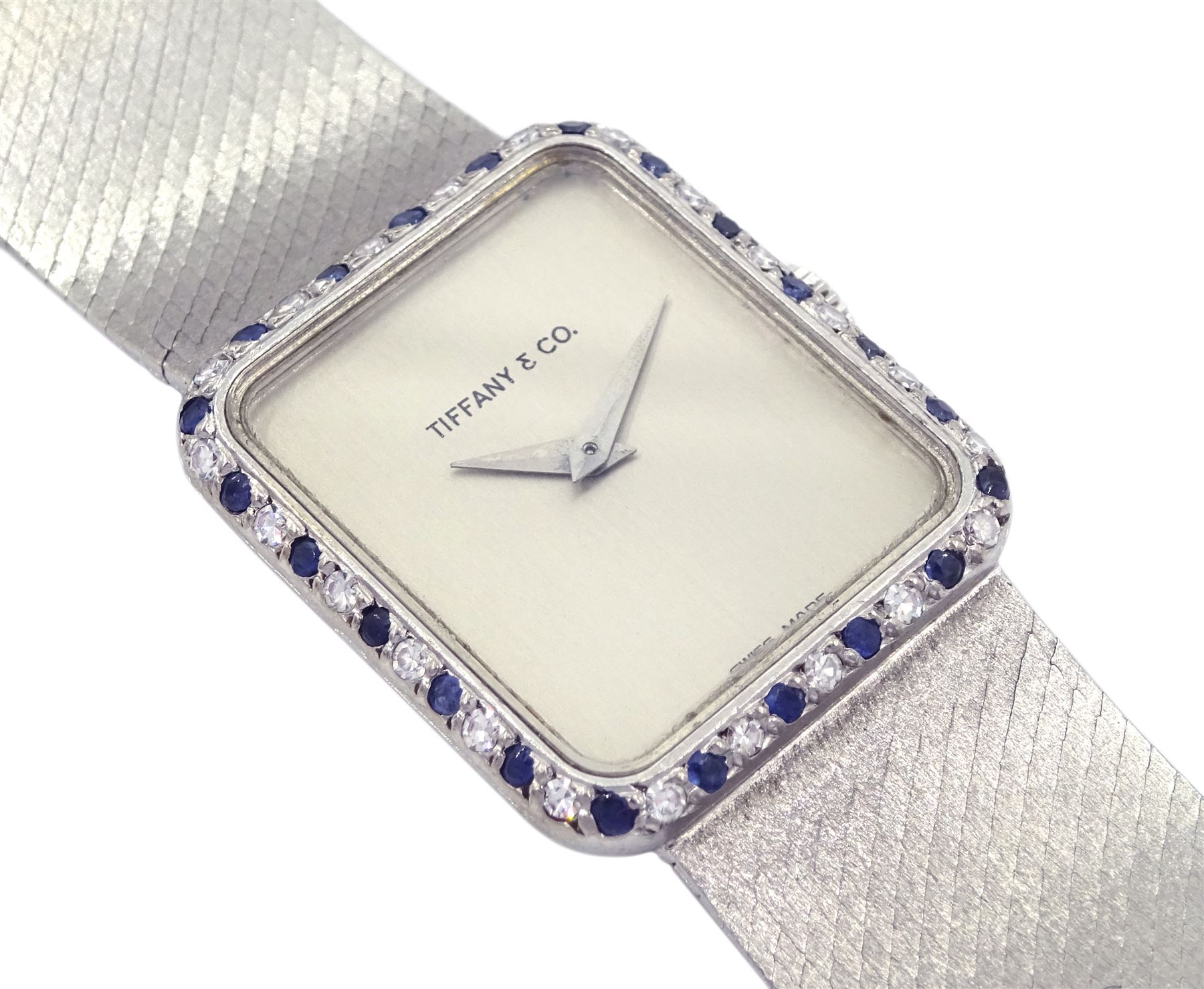 Tiffany & Co ladies 18ct white gold manual wind wristwatch, movement by Chopard, diamond and sapphire bezel, case stamped 18K with Helvetia hallmark, on 18ct white gold integral bracelet, stamped 750