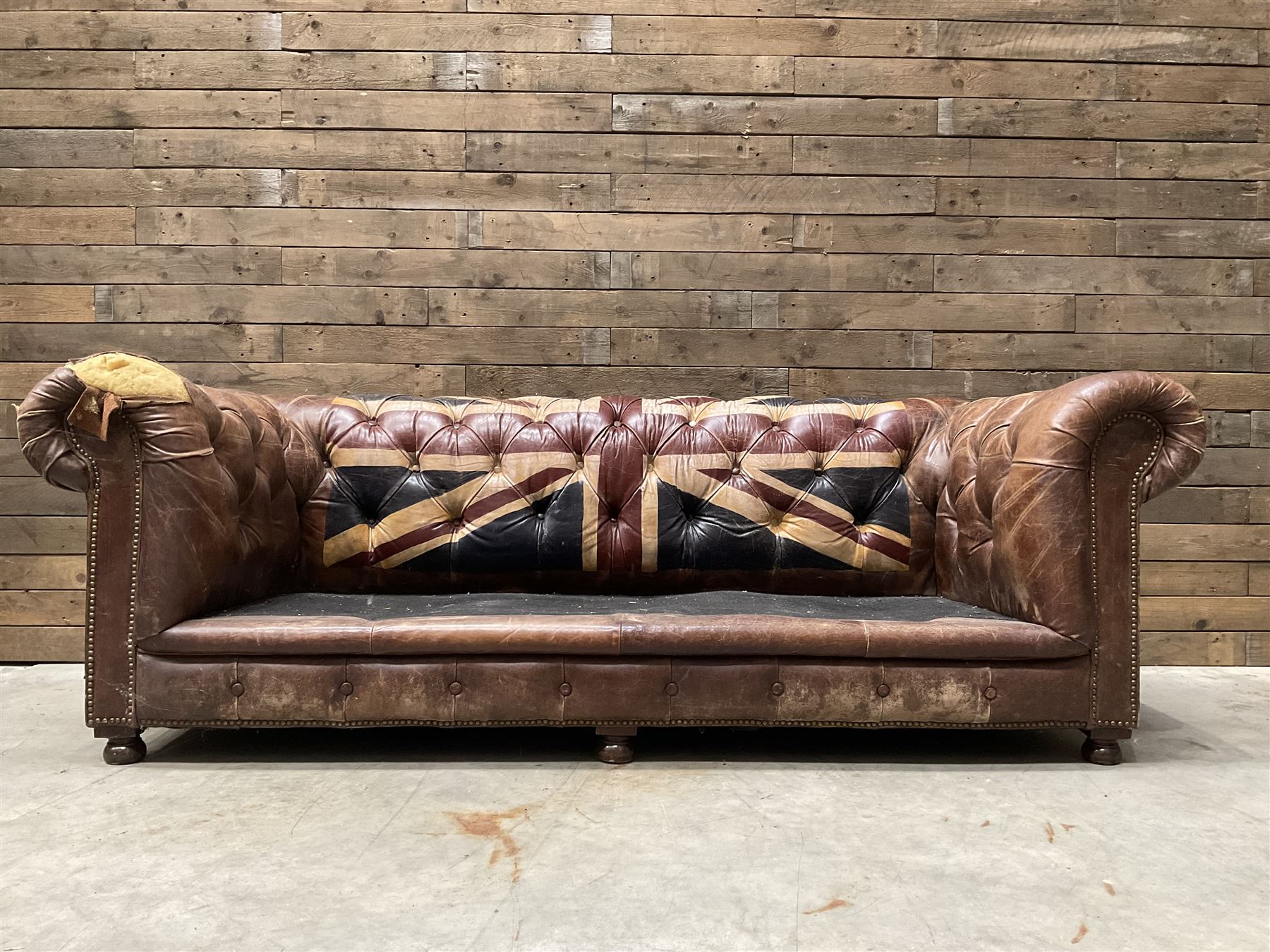 Chesterfield two sofa upholstered in brown leather, with Union Jack pattern, no seat cushions - located in storage, viewing not available