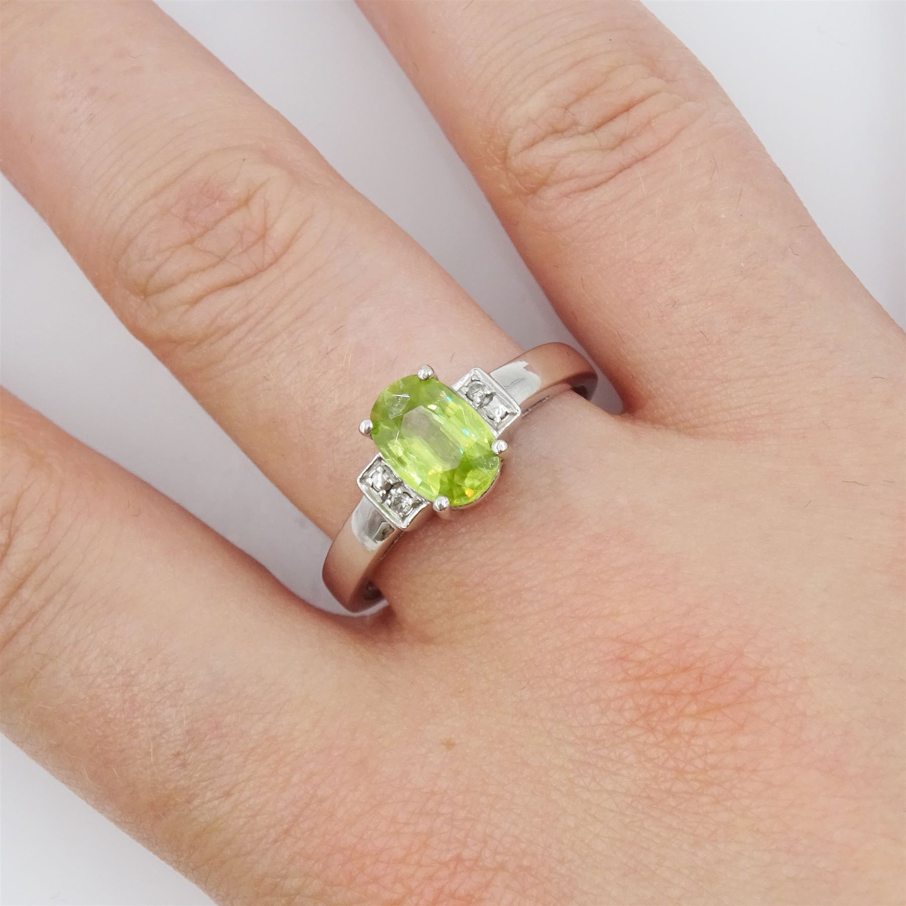 9ct white gold three stone oval cut peridot and diamond ring, hallmarked