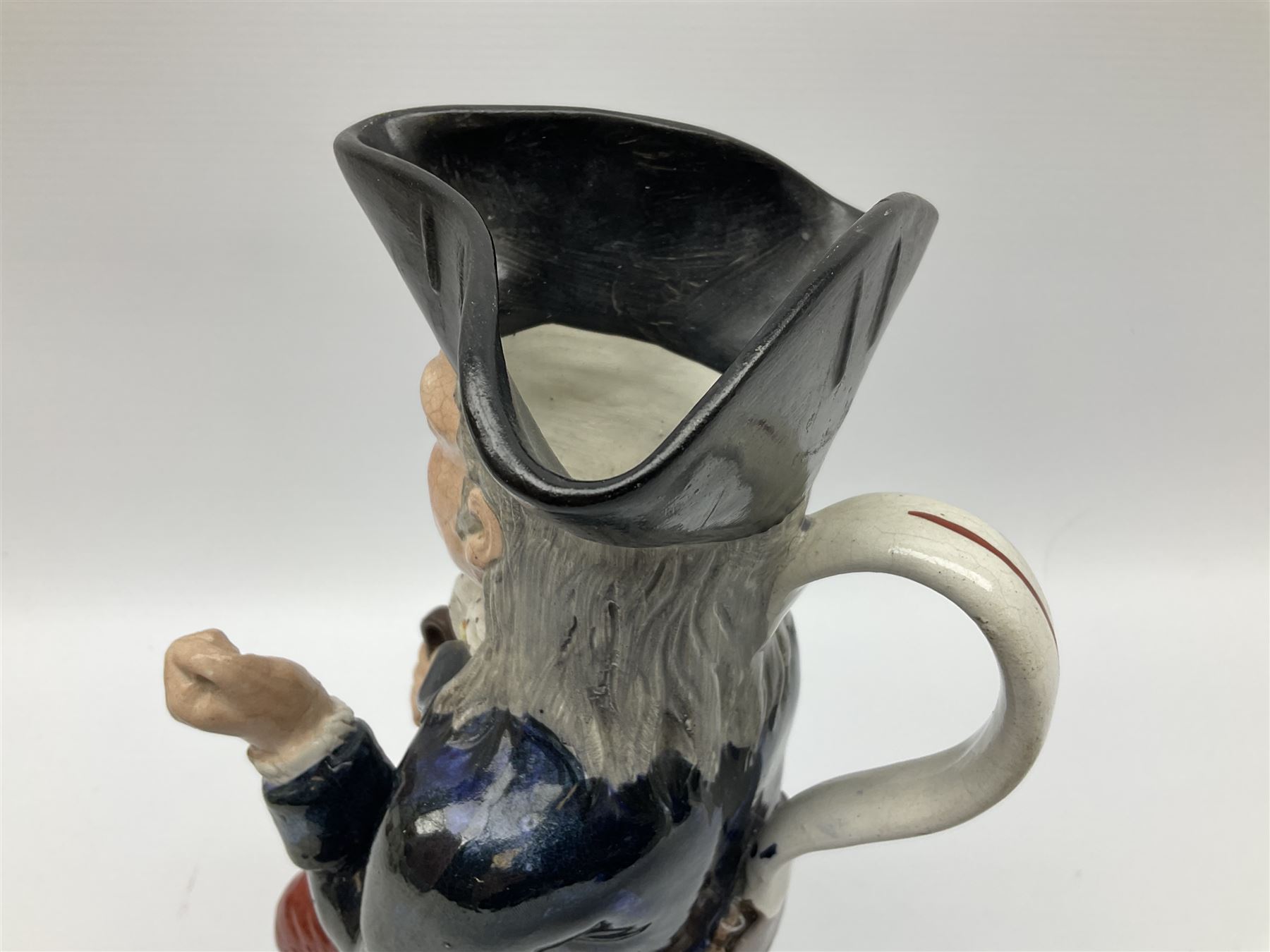 Early 20th century Staffordshire William Kent Squire toby jug, modelled seated upon a corner chair holding a jug of ale in his right hand, H28cm