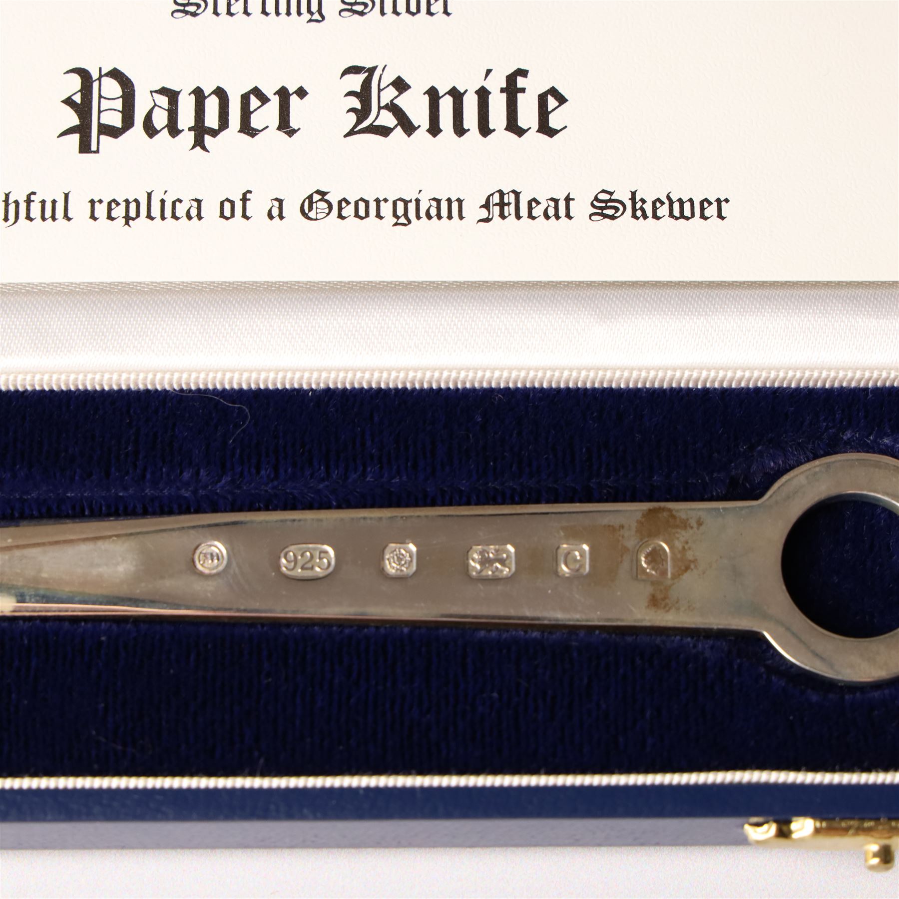 Early 19th century silver caddy spoon, Elizabeth II caddy spoon, various silver condiment spoons, sugar tongs, napkin ring, other silver cutlery and a silver paper knife, boxed