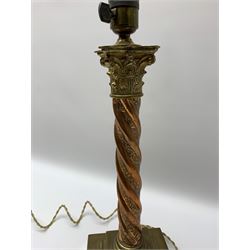 Early 20th century brass and copper Corinthian column table lamp, the square stepped brass base leading to a spiral twist copper column and brass Corinthian capital, H44.5cm 