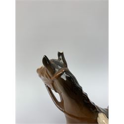 A Beswick equestrian figure modelled as a huntsman on bay horse, with printed mark beneath, together with a Beswick Norman Thelwell figure of a pony and rider, with printed mark beneath  