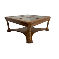 Coffee table, square top with cane work insets, raised on four fluted column supports joined by shaped base