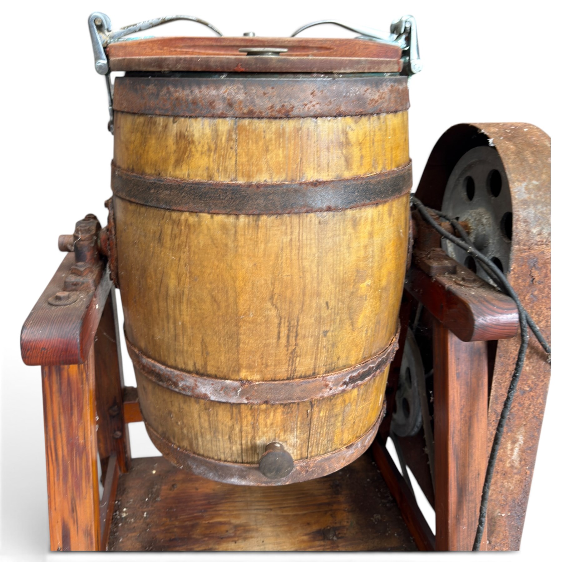 Two early 20th century dairy equipment items: Waide & Sons, Leeds – oak barrel butter churn with iron bands, later converted to electric operation, on trestle stand (W71cm H115cm); Lister – ‘Ball Bearing’ cast iron cream separator, with hopper and foot pedal, in red-painted finish (W47cm H49cm)