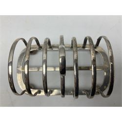 Silver plate seven bar toast rack, of curved form with central ring handle, upon bun feet, H13cm 