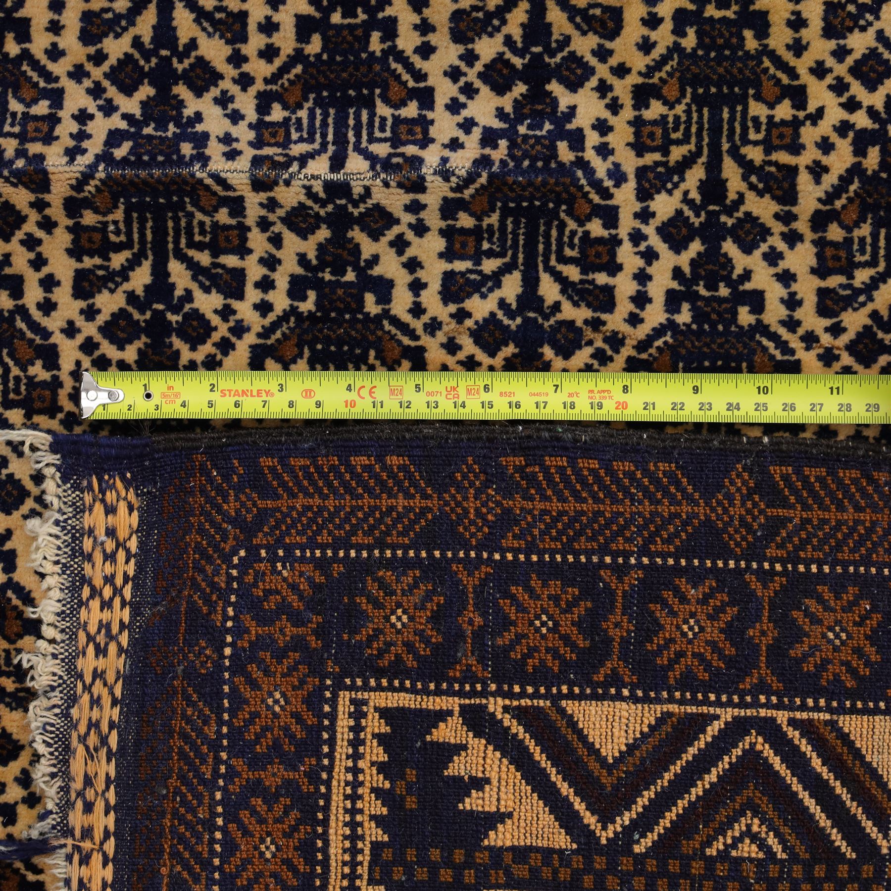 Afghan Ersari hand-knotted rug, apricot field decorated with three large octagonal gul medallions filled with geometric floral motifs, flanked by small tribal devices, end fringe fraying 97x167cm, together with a Baluch prayer rug, decorated with stylized tree motifs arranged in vertical rows beneath a stepped mihrab arch with multiple narrow borders of angular tribal motifs in shades of indigo, brown, and ochre fraying to flatweave ends, 134x84cm, (2)